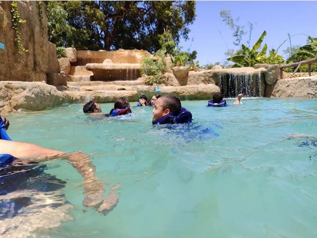Visitors swimming in a freshwater pool at a Punta Cana adventure park