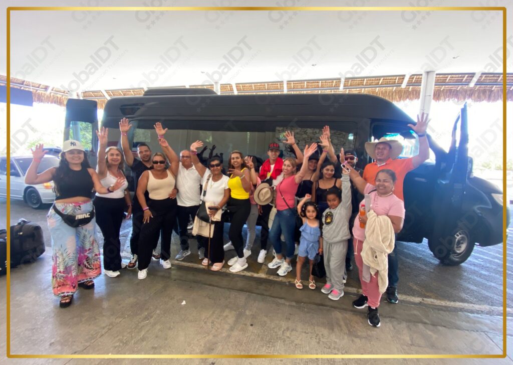 Large group of tourists waving with raised hands in front of a white passenger van at the airport