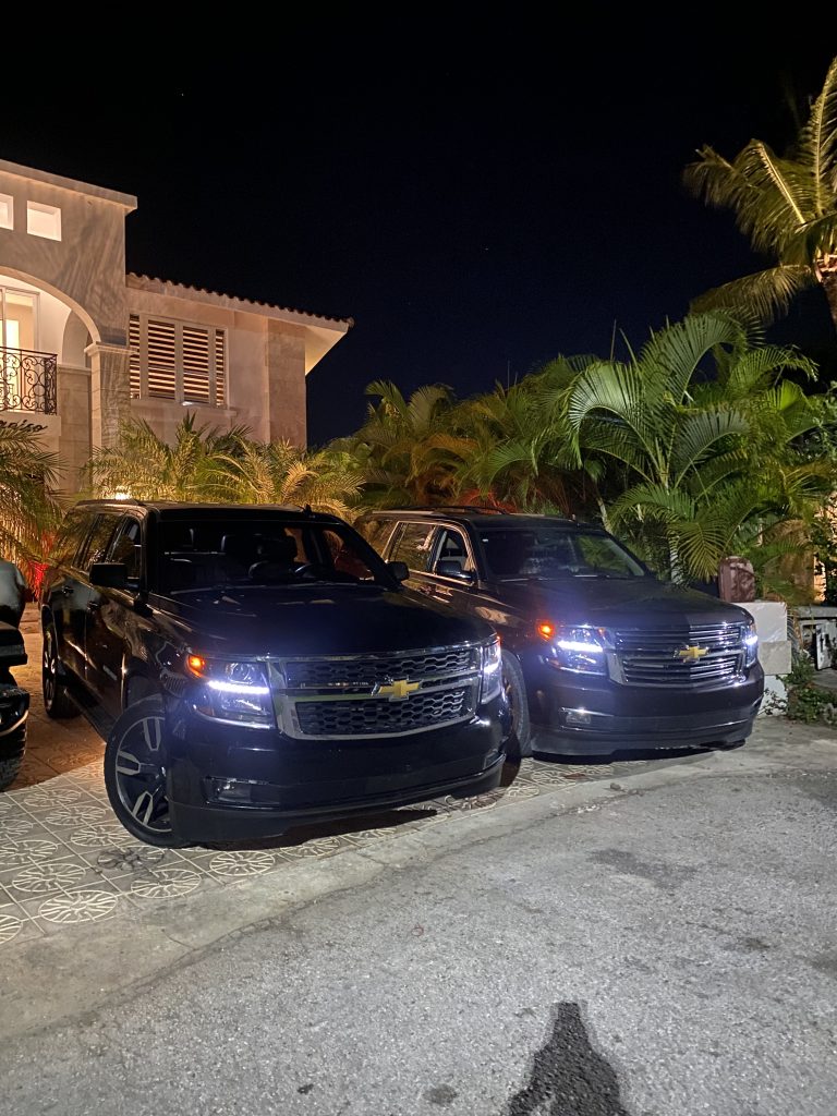 Black Chevrolet Suburban SUVs at a private villa at night in Punta Cana