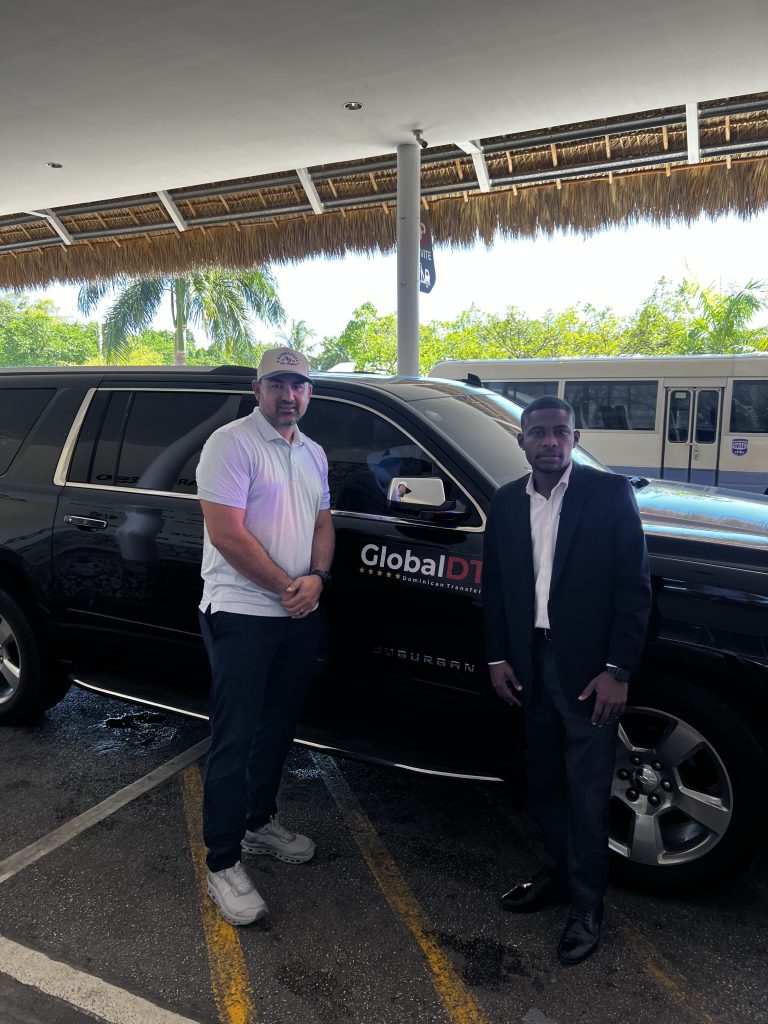 GlobalDT chauffeur with a client beside a black Chevrolet Suburban